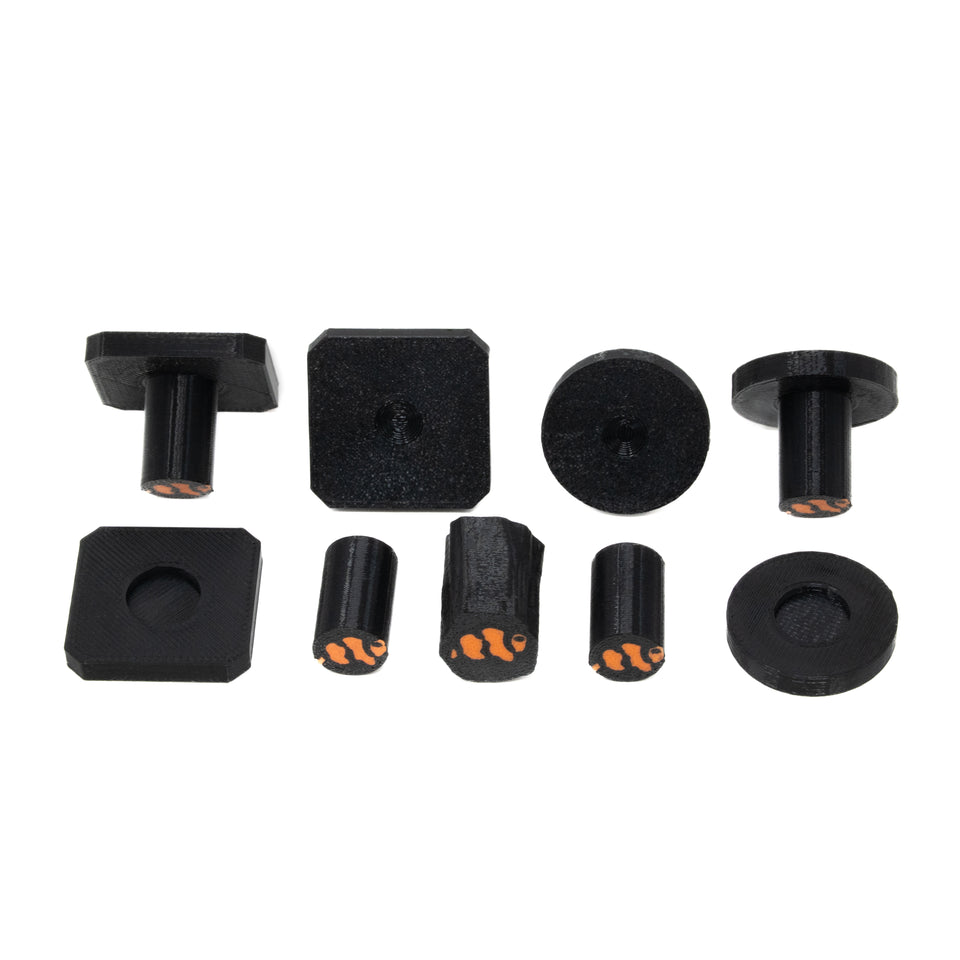 Black Marine Spec frag plugs, round and square tops with detachable stems, laid out together