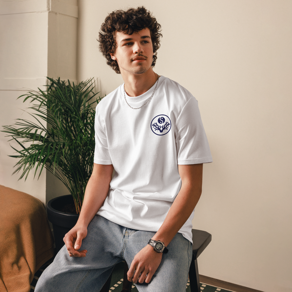 Man seated wearing the white Stay Mindful, Keep Reefing t-shirt, front view