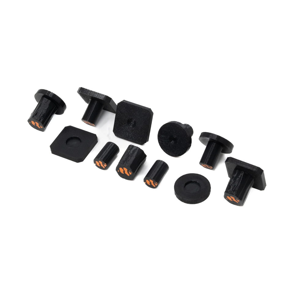 Group of black round and square coral frag plugs with stems on white background