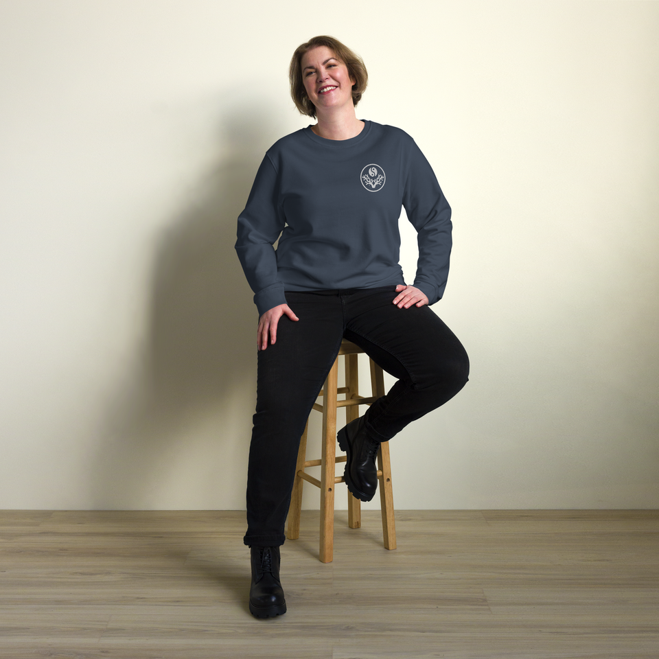 Woman seated wearing the French Navy Reef State, Meditate sweatshirt, front view