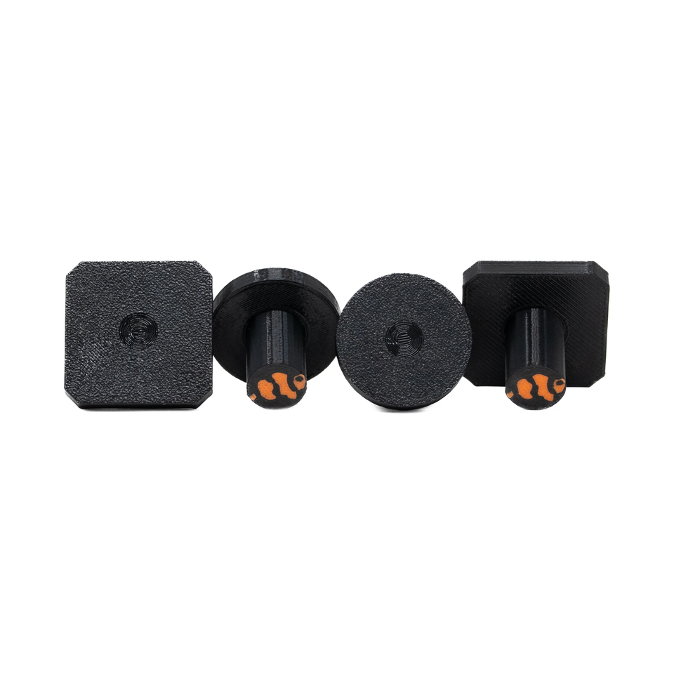 Black round and square frag plugs with stems side by side on white