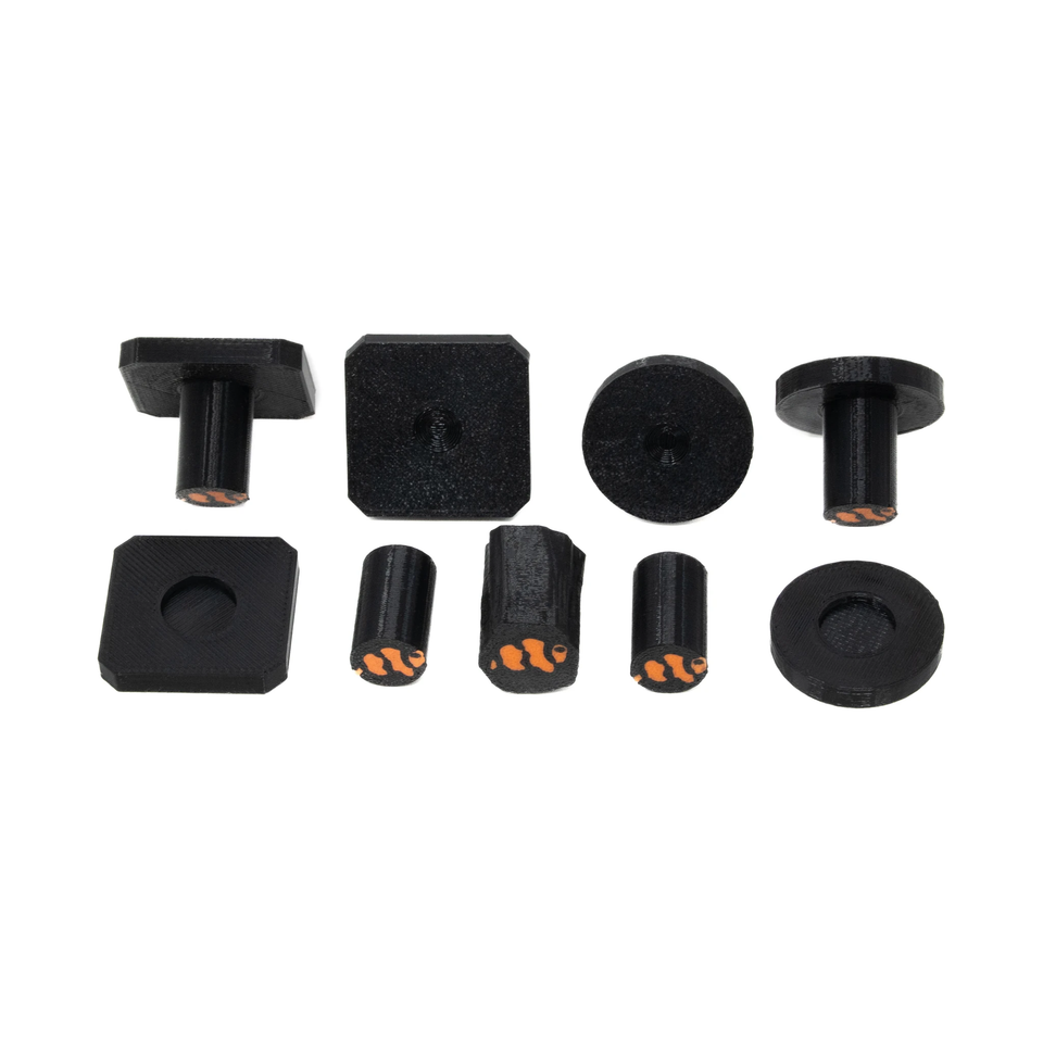 Black Marine Spec frag plugs, round and square tops with detachable stems, laid out together