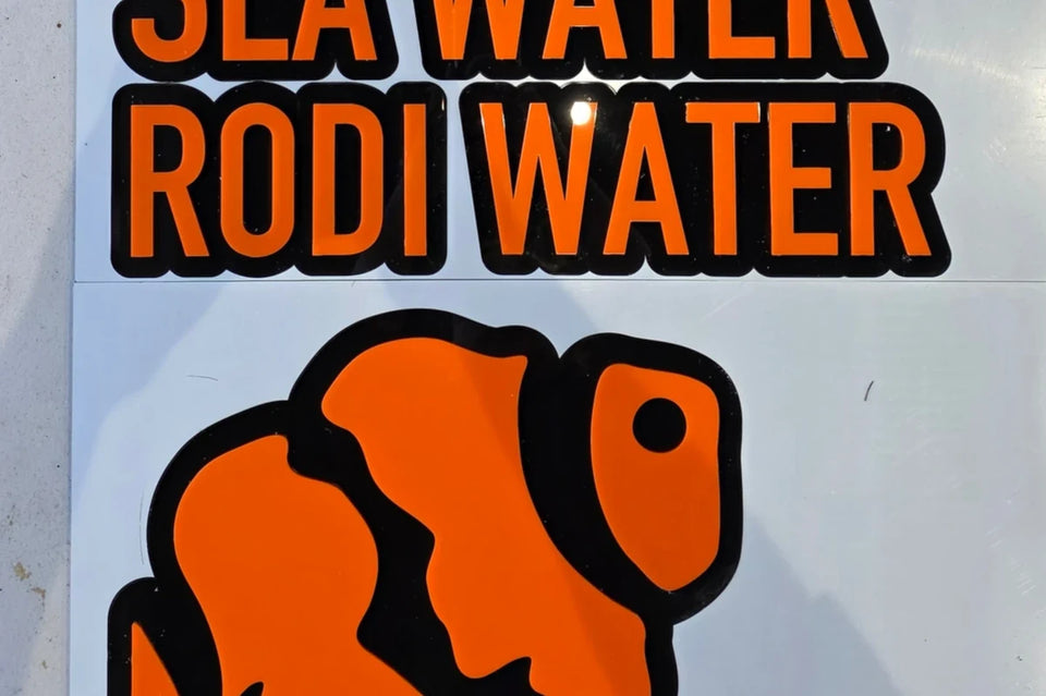 Orange on black acrylic sign reading Sea Water and RODI Water above an orange clownfish