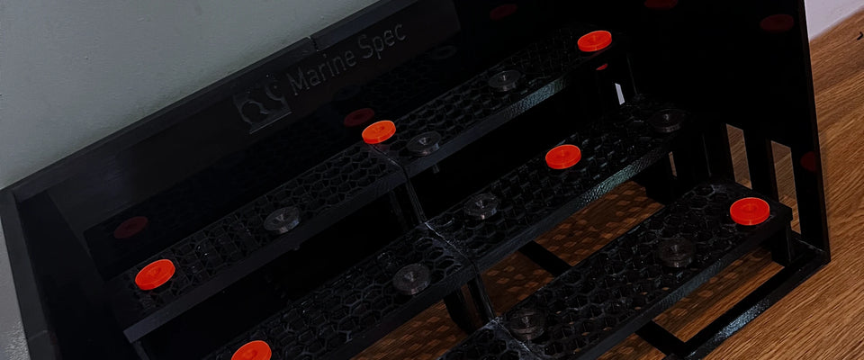 3D printed magnetic nori feeder, frag rack and plug set on a dark lit stage